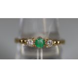 9ct gold three stone emerald and diamond ring. Ring size O. Approx weight 2.2 grams. (B.P. 21% +