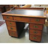 Early 20th century mahogany campaign style knee hole desk, the moulded and leather top above one