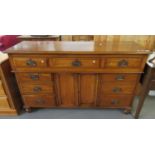 Edwardian oak sideboard with a moulded top, having an arrangement of three drawers, and central