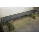 Garden bench having weathered composition stands on a slate slab seat. (B.P. 21% + VAT)