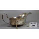 Early 20th century silver Georgian style sauce or gravy boat on hoof feet with initial E.V.