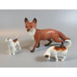 Beswick study of a prowling fox, together with two Beswick terrier hunting dogs. (3) (B.P. 21% +