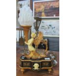 Classical style table lamp with a figure of a nude lady with gilt wings holding a torch style flambe