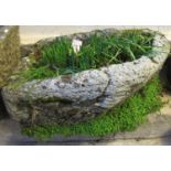 Weathered composition stone planter with plants. (B.P. 21% + VAT)