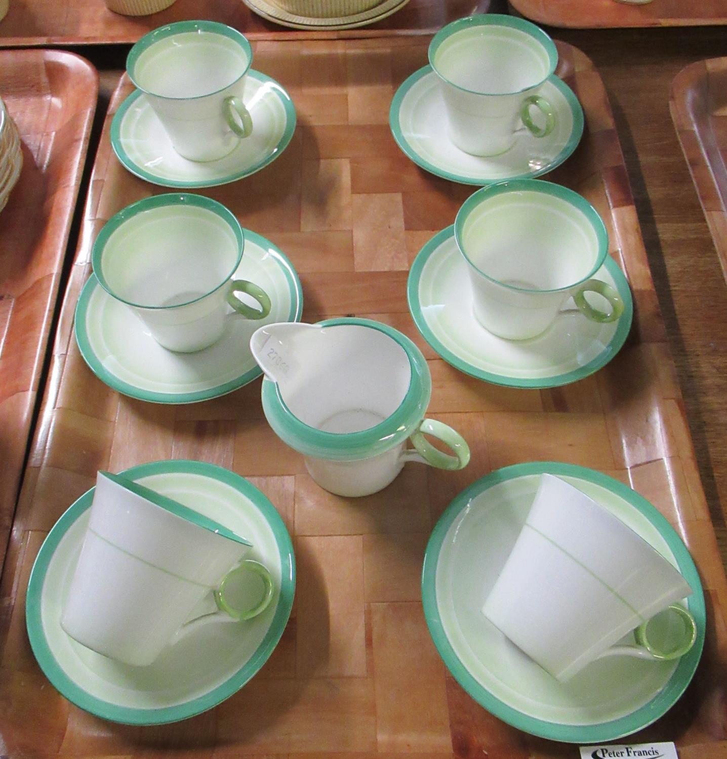 Tray with six Shelley fine bone china cups and saucers, together with a milk jug, decorated in white