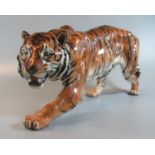 Royal Doulton china study of a prowling Tiger. 36cm long approx. (B.P. 21% + VAT) No obvious