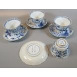 Set of four blue and white porcelain tea bowls and saucers moulded and painted with landscapes and