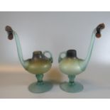 A pair of unusual probably Middle Eastern design single handled jugs or vessels, the spout with