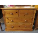 Modern pine straight front bedroom chest with two short and two long drawers on a platform base.