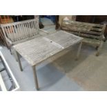 Two weathered teak garden benches, together with a teak garden table. (3) (B.P. 21% + VAT)