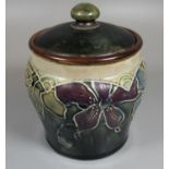 Royal Doulton stoneware lidded tobacco jar, having tube lined floral and foliate decoration,