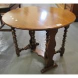 Early 20th Century oak drop leaf table of small proportions with shaped sides and turned legs. Fully