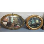 Art nouveau beaten brass bevel plate oval mirror, together with an oval gilt frame mirror with