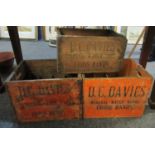 A pair of vintage stained pine two handled bottle crates marked 'D.C. Davies Mineral Waterworks