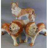 Pair of early 20th Century Staffordshire fireside lions with glass eyes, together with a pair of