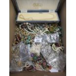 A collection of costume jewellery including a cased set of simulated pearls, silver plated buckle