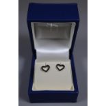 Pair of 9ct white gold heart shaped earrings set with black diamonds. Approx weight 1 gram. (B.P.