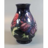 Modern Moorcroft art pottery tube lined anemone pattern vase of baluster form. 14cm high approx.