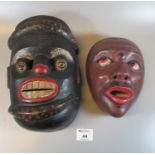 Two polychrome decorated carved wooden masks, one African, one possibly Japanese. 27cm & 21cm high