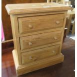 Miniature pine table top straight front chest of three drawers on a platform base. 40 x 22 x 47cm