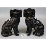Pair of Staffordshire pottery black seated fireside Spaniels with open cast feet. (2) (B.P. 21% +