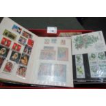 Red box of all world stamps in small stock books, on cards, in envelopes, presentation packs and