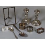 Bag of silver items to include; pair of candlesticks of baluster form with loaded bases, napkin