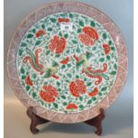 Japanese porcelain charger overall with double phoenix flying amongst peony blossoms. Iron red six