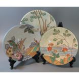 Three Art Deco design Crown Devon Fieldings tube lined chargers, overall with floral, seascape and