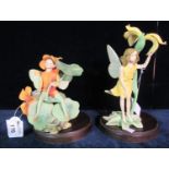 Two Border Fine Arts figurines of fairies with wings; one sitting on a lily pad. On wooden bases. (