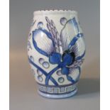 Charlotte Rhead Bursley ware tube lined vase, overall with berries and foliage and a geometric base.