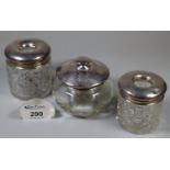 Pair of hob nail cut silver topped dressing table jars, together with another silver topped jar of