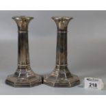 Pair of silver candlesticks by W.L & S Sheffield, standing on octagonal loaded bases. 16.5cm high