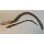 Vintage scythe with turned wooden handle, together with a smaller similar scythe with turned handle.