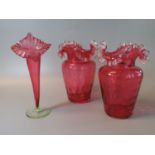 Three items of Victorian cranberry glass to include; pair of vases and an epergne vase. (3) (B.P.