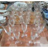 Set of eight fluted and etched foliate champagne flutes, together with a set of 12 matching wine