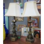 Pair of modern gilded cast metal and marble table lamps with shades, modelled as cherubs on a scroll