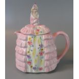 A 'Ye Daintee Ladyee' earthenware novelty teapot, the lid modelled as a crinoline woman on a pink