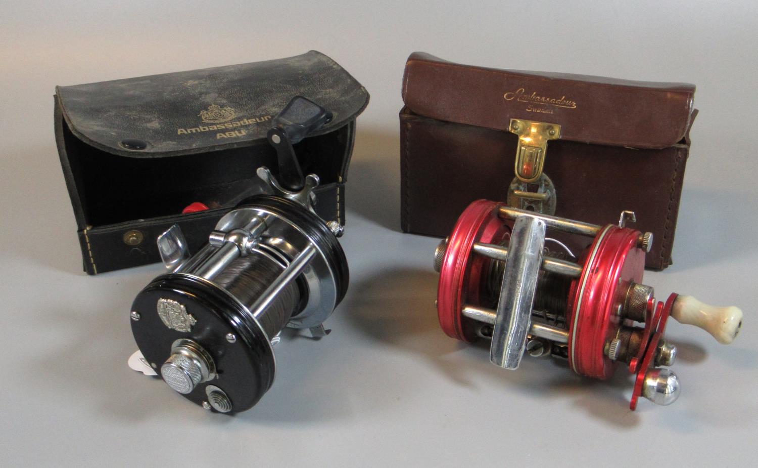 Abu Ambassadeur 6000 fishing reel in leather carrying case, together with another Abu Ambassadeur
