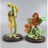 Two Border Fine Arts figurines of fairies with wings; one sitting on a lily pad. On wooden bases. (