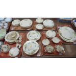 Six trays of Royal Doulton 'Minden' dinner ware with stylised pastel coloured flowers on a cream