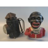 Cast metal novelty black man money box, together with a metal handheld probably policeman's oil lamp