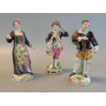 Three continental porcelain figurines of a woman and two gentlemen in 18th century dress, all on