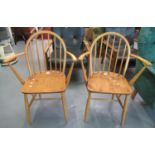 Pair of Ercol elm and beech hoop and spindle back open armchairs. Impressed marks to the base BS