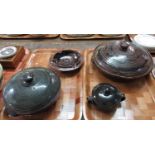 Group of Nigerian Abuja stoneware pottery items to include; two circular tureens and covers, both