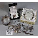 Collection of silver and white metal jewellery including a wide engraved silver bangle. (B.P.