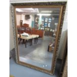 Modern gilt framed mirror overall with moulded flowers and foliage to the frame. 72 x 104cm