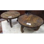 Pair of carved hardwood stools of low circular form, overall with flower decoration. 27cm