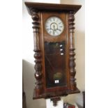 Early 20th Century walnut two train wall clock marked 'Manufactured by Waterbury Clock Co, USA'. (