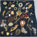 Collection of vintage brooches to include flowers and foliage, butterflies, cameo design, etc. (B.P.